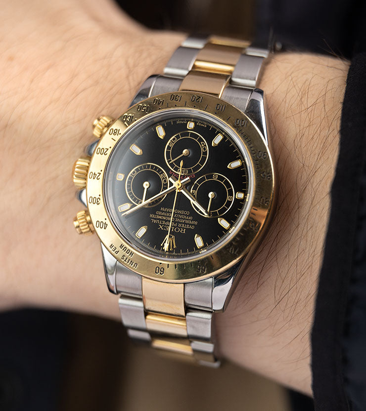 Rolex daytona black on sale gold