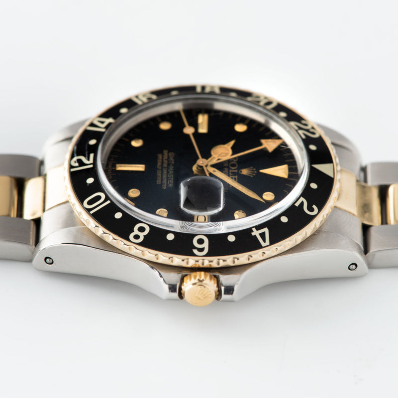 Rolex 16753 Black Nipple Dial GMT Master with a yellow gold winding crown